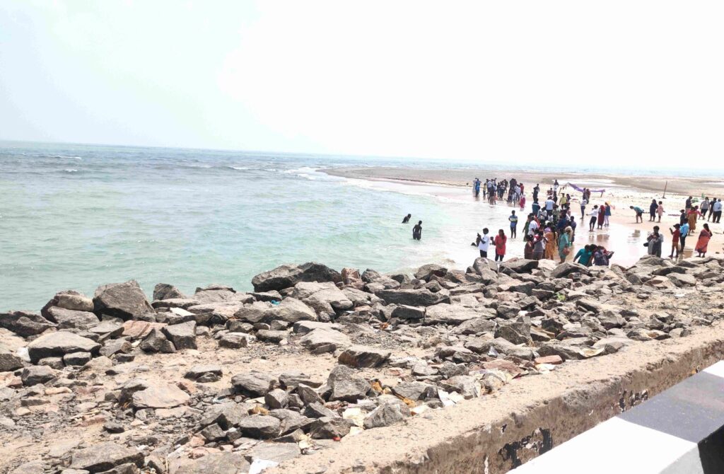 View of Dhanushkoti shoreline with calm water and sandy ground, showcasing the remote and silent landscape of the ghost town in Tamil Nadu, India.
