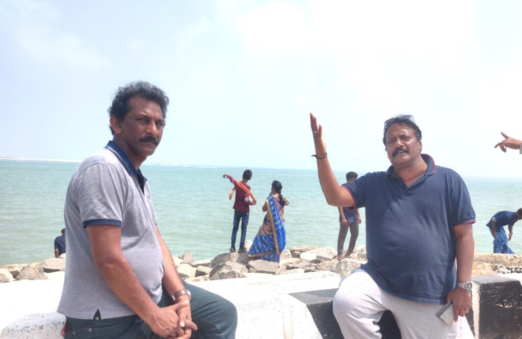 Tourists standing by the seashore at Dhanushkoti, Tamil Nadu, enjoying the coastal view at the last land point of India.