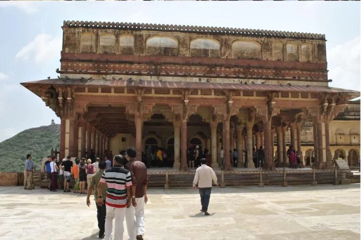 Tourists exploring the Diwan-i-Aam (Hall of Public Audience) at Amer Fort in Jaipur, Rajasthan.