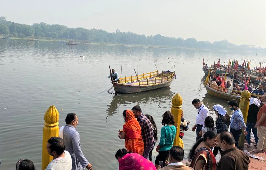 Devotees gathered along the steps of Vishram Ghat on the banks of River Yamuna in Mathura, Uttar Pradesh, India, preparing for boat rides and rituals at this sacred site associated with Lord Krishna
