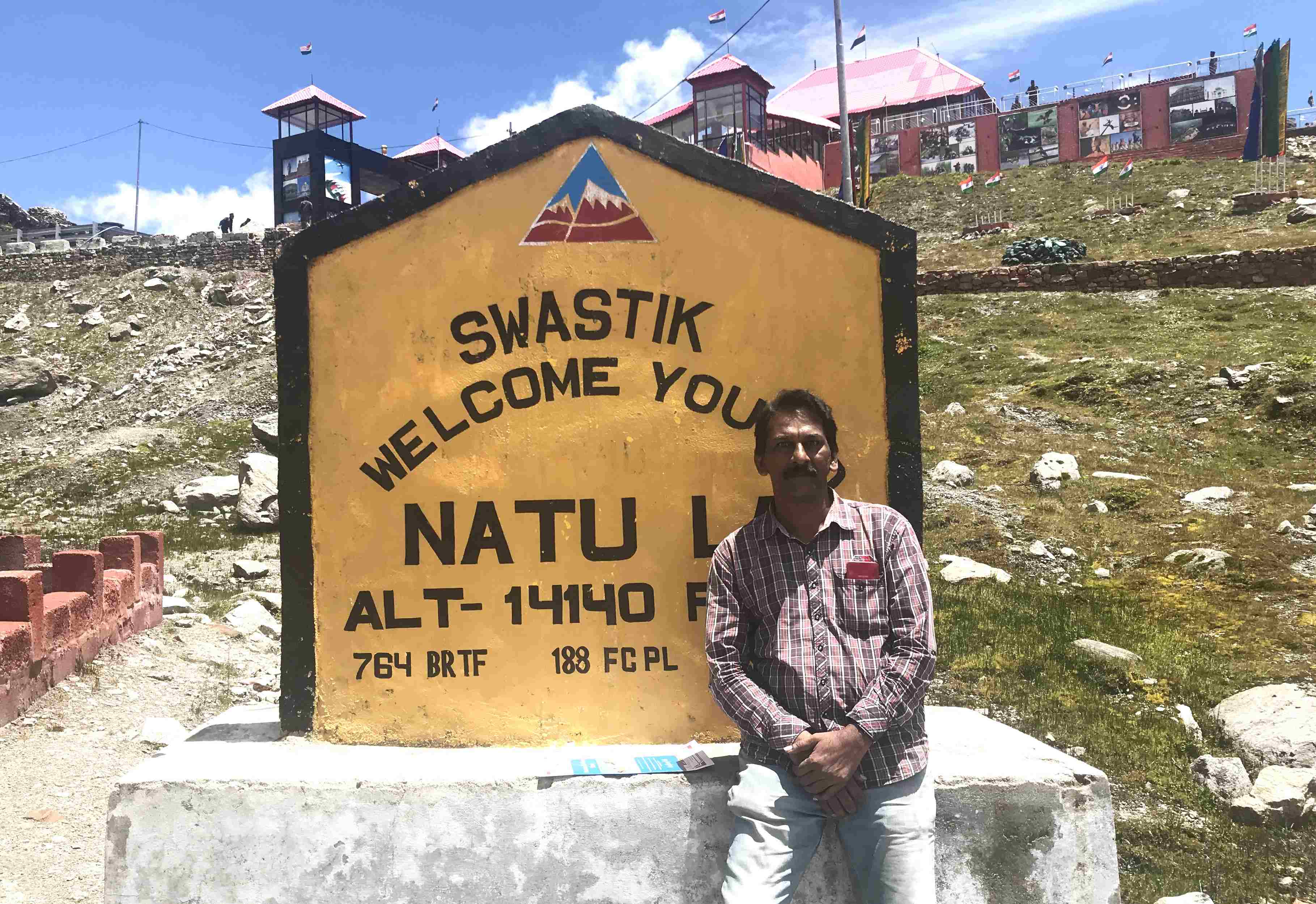 View of Nathula Pass at the India-China border, surrounded by snow-clad mountains and high-altitude terrain.