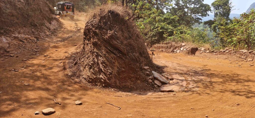 A jeep navigating a rough, sharp curve on the return route from Kudajadri”