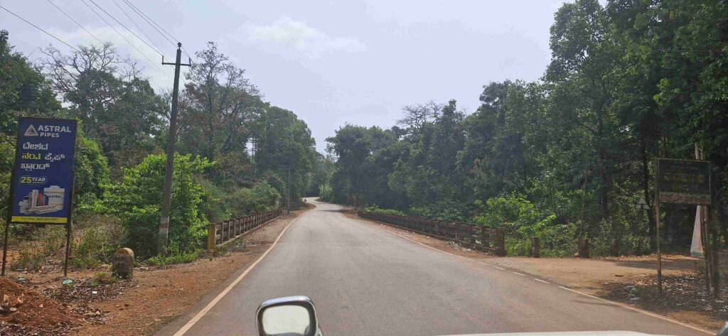 Smooth highway road surrounded by greenery on the way back from Kudajadri to Mookambika