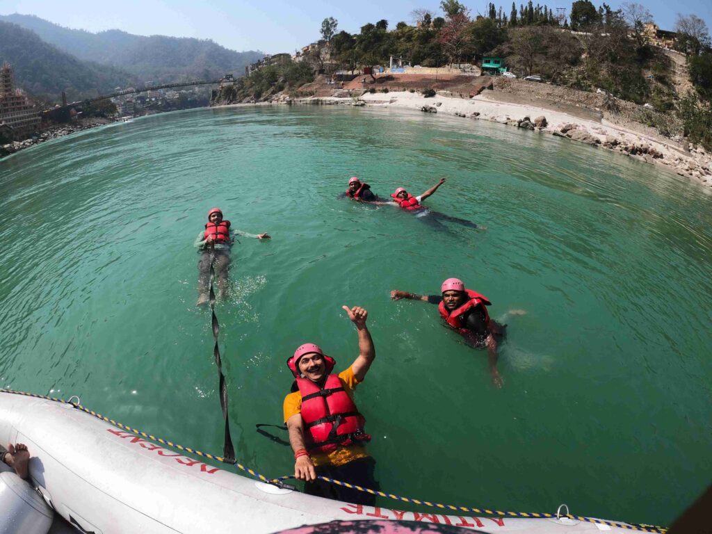 Rafting group relaxing inside the calm waters of River Ganga, Rishikesh