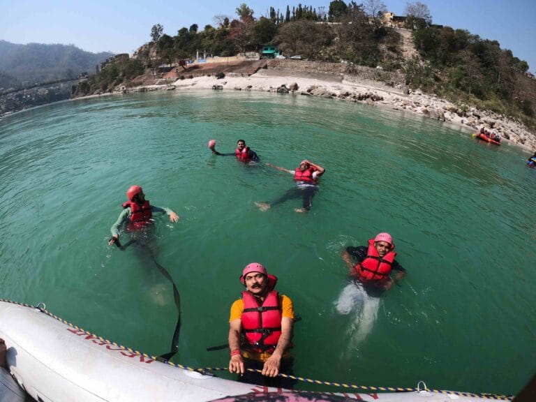 Rafting group relaxing inside the calm waters of River Ganga, Rishikesh