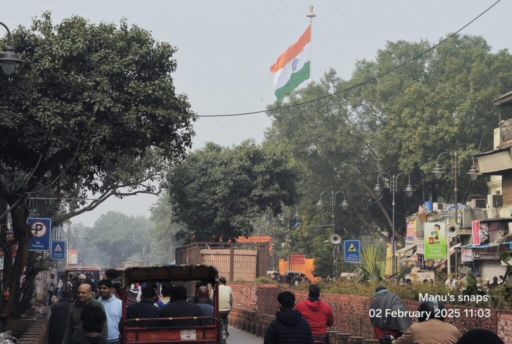 Busy street life in Chandni Chowk Delhi with rickshaws and pedestrians