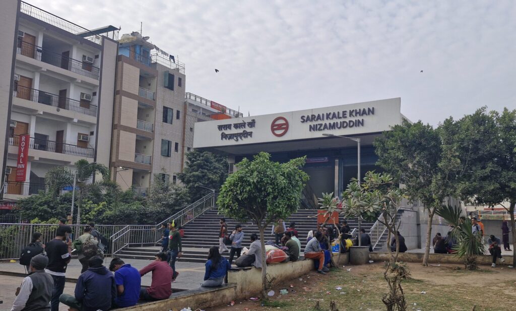 Entrance of Sarai Kale Khan Nizamuddin metro station with commuters and pedestrians in Delhi