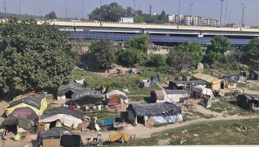 Temporary shelters and huts beneath elevated road in Delhi