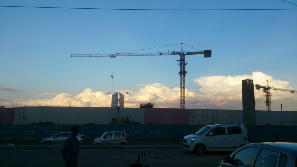 Construction cranes and traffic near developing skyline in New Delhi