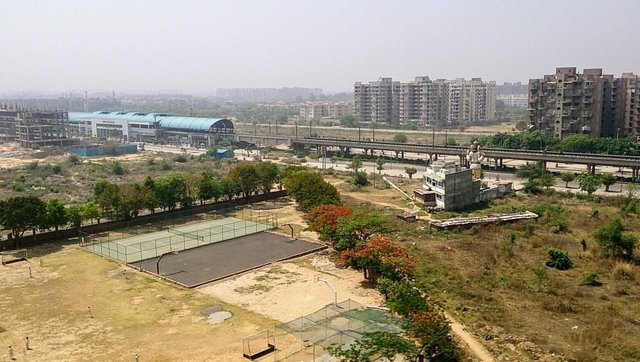 Delhi neighbourhood with metro station school playground and Hanuman temple